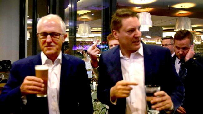 Malcolm Turnbull is photobombed as he is pictured with MP Ross Vasta meeting the locals at the Carindale Hotel in Brisbane last night. Picture: AAP