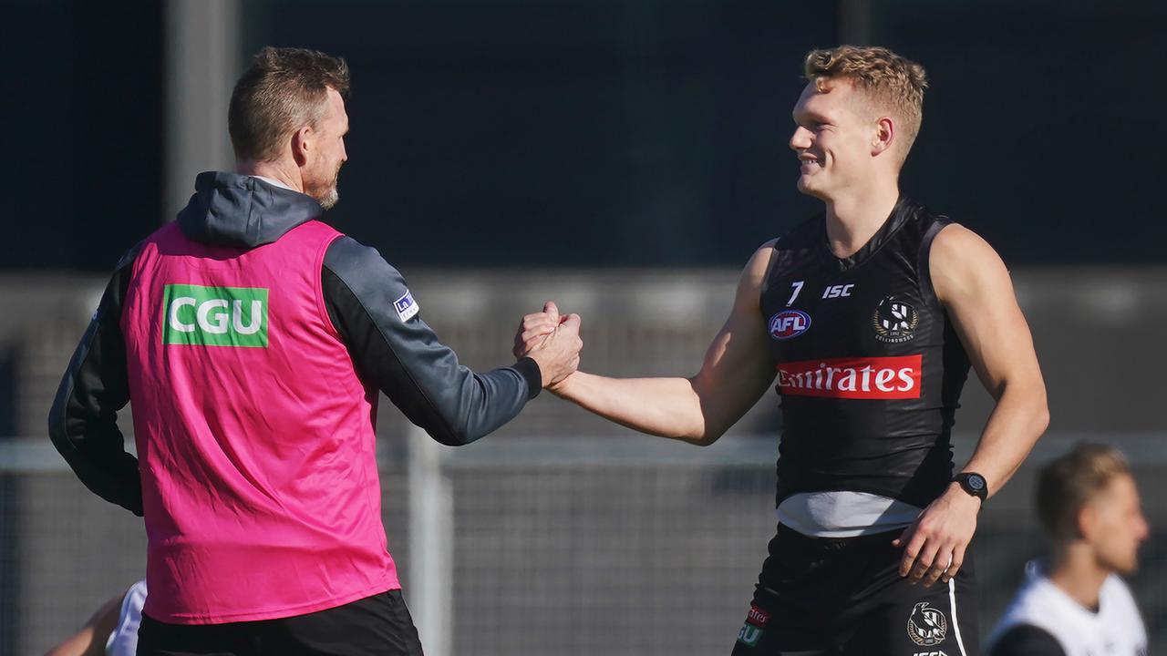 Magpies head coach Nathan Buckley shakes hands with Adam Treloar in June. Picture: Michael Dodge/AAP