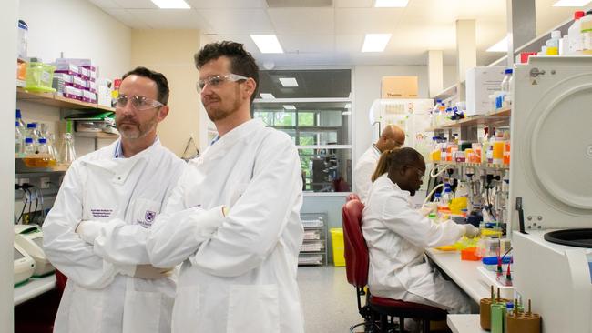 The University of Queensland’s Keith Chappell (standing right) with his team who are working on a vaccine for the coronavirus.