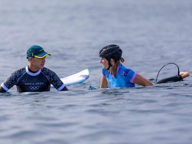 Molly Picklum of Team Australia talks with head coach Bede Durbidge following her heat during round two of surfing in Tahiti. Picture: Ed Sloane / POOL / AFP