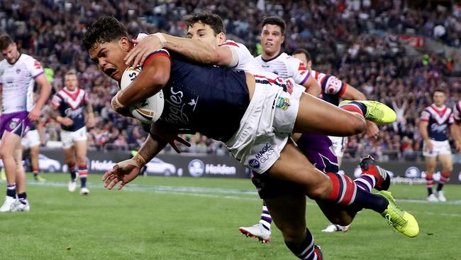 Latrell Mitchell smashes through the gap to score. (Mark Kolbe/Getty Images)