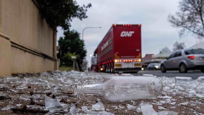 Up to 2000 bottles were strewn over South Rd. Picture: Mark Brake