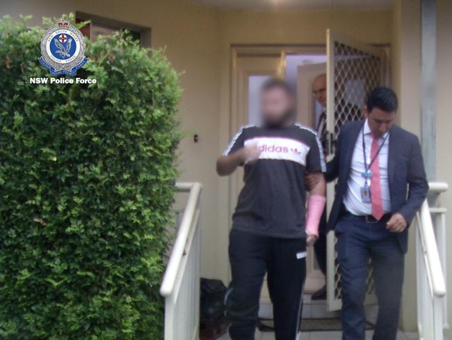 Fayez Kaanan being escorted from a property on January 16, 2020. Picture: NSW Police