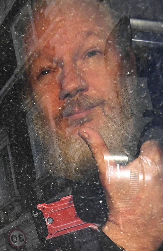 Julian Assange gestures as he arrives at Westminster Magistrates' Court in London, where he appeared in front of a judge who has called him a “narcissist”. Picture: Victoria Jones/PA/AP