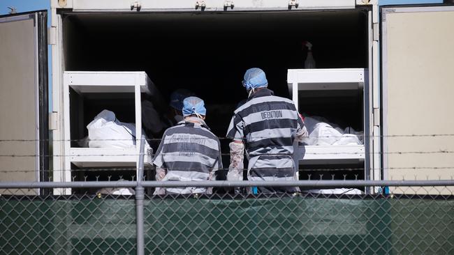 Low-security prisoners unload bodies at a temporary morgue in a carpark in El Paso, Texas, on Tuesday. Picture: AFP