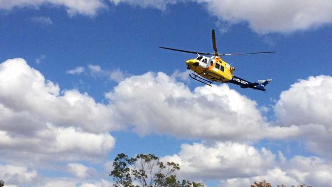 The RACQ rescue crew drops into the Gogango school oval to teach Gogango kids about road safety. Inset Amelia Ward from Gogango State School gets winched into the RACQ rescue helicopter. Picture: contributed