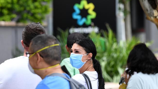 Laid off workers gather outside a Centrelink office. Many other workers are receiving JobKeeper payments, but with government money yet to flow through to companies, employer tensions are rising. Picture: AAP