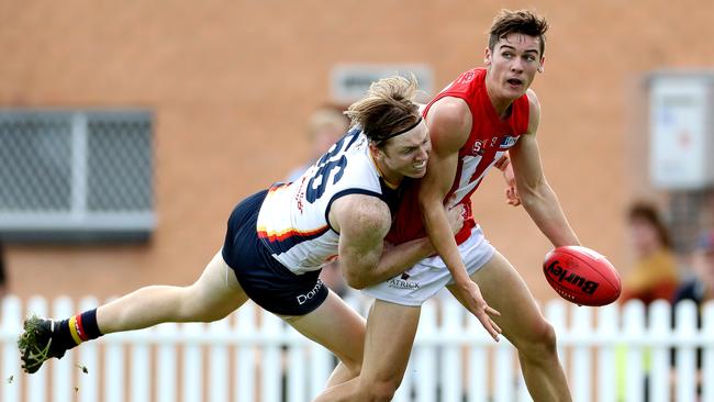 Adelaide’s James Loneragan tackles North Adelaide second gamer Connor Rozee at Prospect Oval on Saturday.    Picture: Callum Robertson