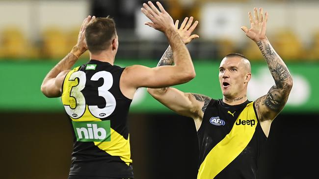 Richmond’s Kamdyn McIntosh, left, and Dustin Martin celebrate against the Suns at the Gabba. Picture: Getty Images