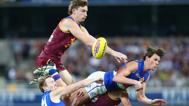 Lion Harris Andrews and Bulldog Patrick Lipinski lose their balance as they fly over the top of Bailey Dale and Marcus Adams yesterday. Picture: Getty Images