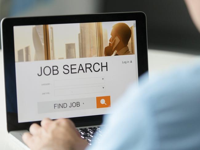 Monitor view over a male shoulder, job search title on the screen, close up. Education, business concept photo