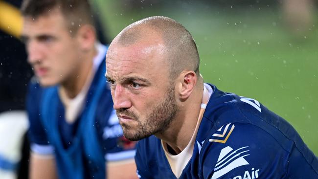 Josh Hodgson watches on from the bench against the Broncos. Picture: Getty