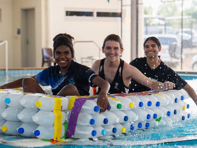 Henbury School students Natalia, Jade, and Dennis prepare their boat for the Beer Can Regatta, 2024. Picture: Pema Tamang Pakhrin