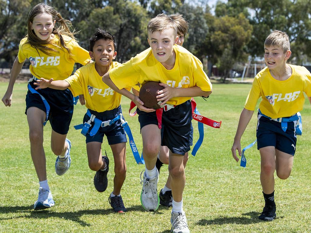 Kidman Park NFL Teams Archie Ferris goes for a touch down chased by Paige Schroeder, Ky Morata, Charlie Castro-Winner and Hayden Ashfield, at Kidman Park Primary school before the head off to represent SA in the nationals. Wednesday, October, 30,2024. Picture Mark Brake