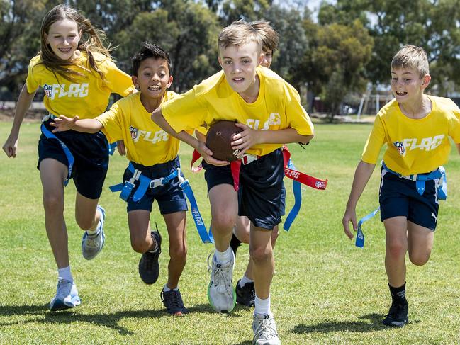 Kidman Park NFL Teams Archie Ferris goes for a touch down chased by Paige Schroeder, Ky Morata, Charlie Castro-Winner and Hayden Ashfield, at Kidman Park Primary school before the head off to represent SA in the nationals. Wednesday, October, 30,2024. Picture Mark Brake