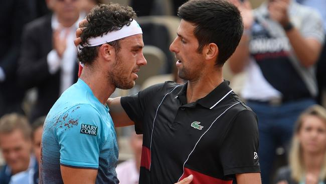 Novak Djokovic congratulates Marco Cecchinato after the Italian’s upset win. Picture: AFP.