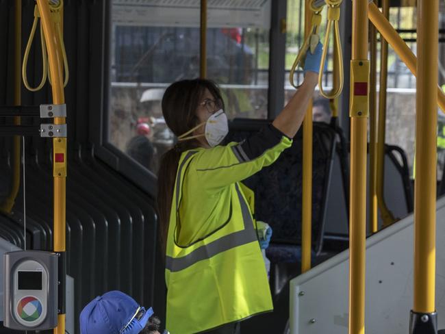 SYDNEY, AUSTRALIA - APRIL 29: Cleaners are pictured at work while wearing PPE at the Waverley Bus Depot on April 29, 2020 in Sydney, Australia. NSW Treasurer Dominic Perrottet said in a statement the equivalent of 3000 full-time cleaners would be working by the end of June in an effort to help combat COVID-19 in New South Wales.  (Photo by Brook Mitchell/Getty Images)