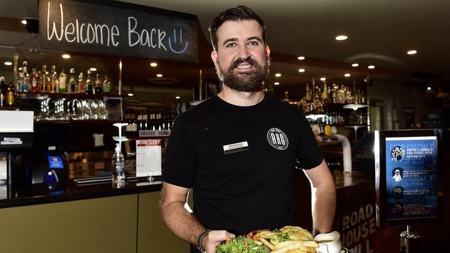 Venue manager Anthony Robertson serves a pub meal as Covid-19 restrictions begin to lift. Tom's Tavern has reopened for pub meals. PICTURE: MATT TAYLOR.