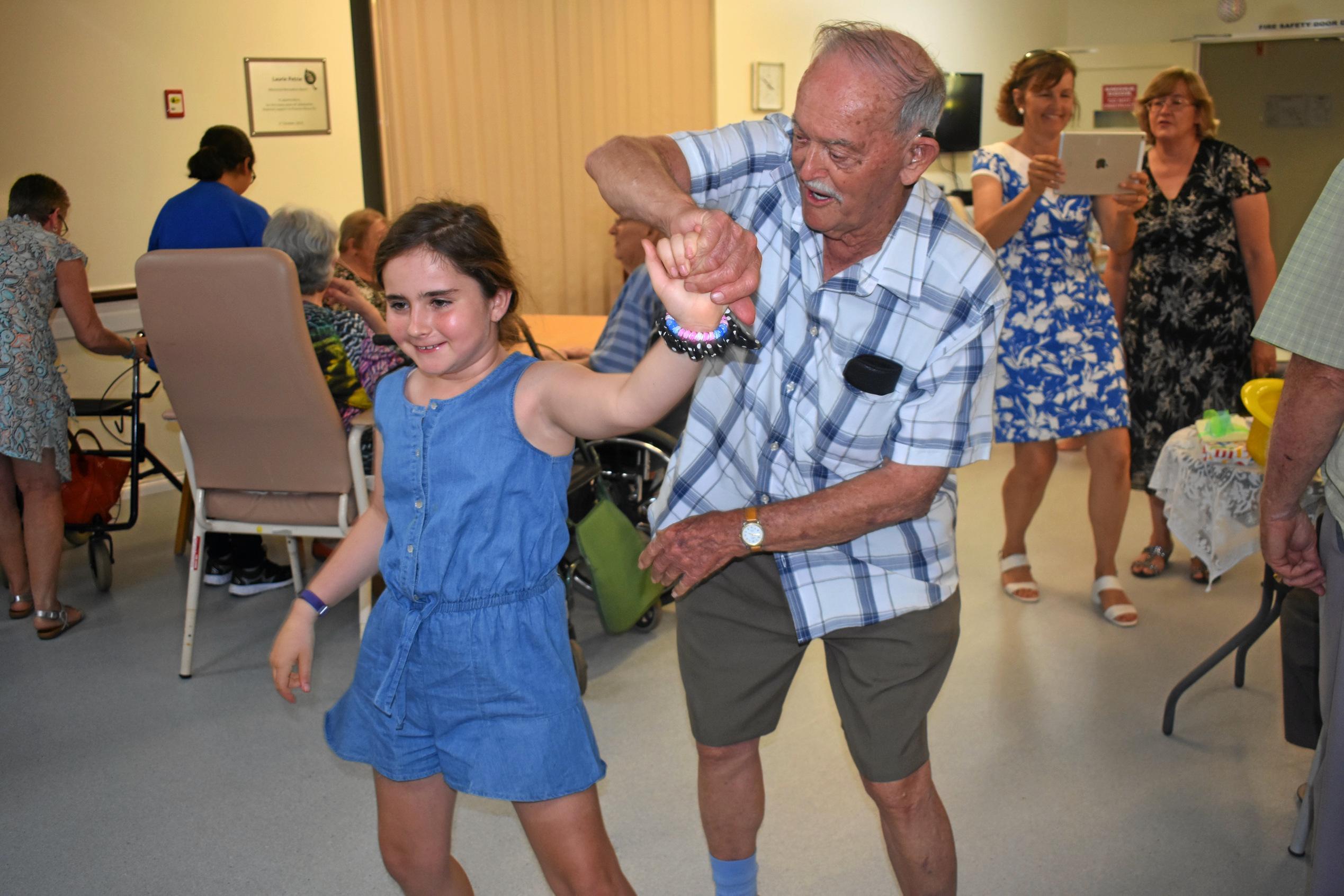 Kevin Kruger takes Charly Denton for a twirl at Dexter Kruger's 109th birthday party. Picture: Jorja McDonnell