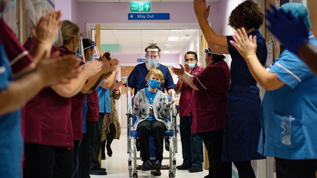 Margaret Keenan, 90, is applauded by staff as she returns to her ward after becoming the first person in the United Kingdom to receive the Pfizer/BioNtech covid-19 vaccine. Picture: Getty