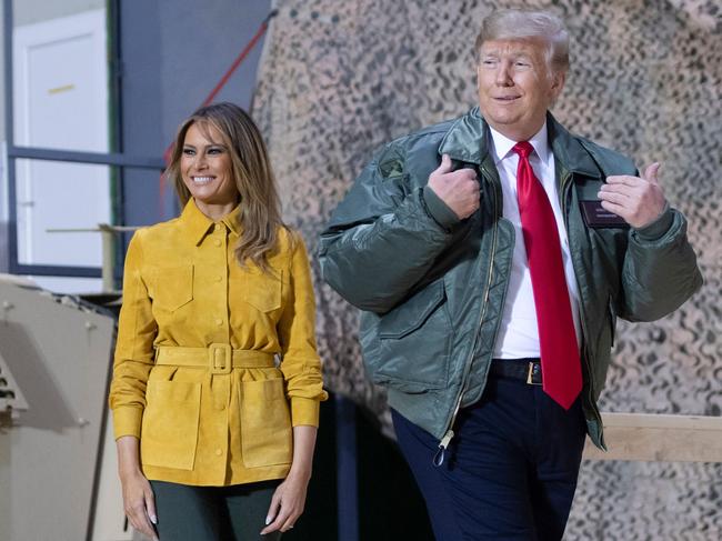 TOPSHOT - US President Donald Trump and First Lady Melania Trump arrive to speak to members of the US military during an unannounced trip to Al Asad Air Base in Iraq on December 26, 2018. - President Donald Trump arrived in Iraq on his first visit to US troops deployed in a war zone since his election two years ago (Photo by SAUL LOEB / AFP)