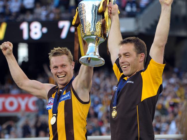 Sam Mitchell and coach Alastair Clarkson lift the AFL premiership cup in 2008.