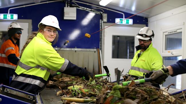 Workers remove non-organic items from a conveyor belt at waste company Veolia’s Tarago eco-precinct in NSW. Picture: Jane Dempster