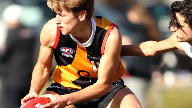 Melbourne Australia - July 15 Dandenong Stingrays number 18 Mitchell Riordan with the ball as 19 Christian Farchione attempts to tackle for the Northern Knights.TAC Cup: Dandenong Stingrays v Northern Knights.Picture: Stuart Milligan