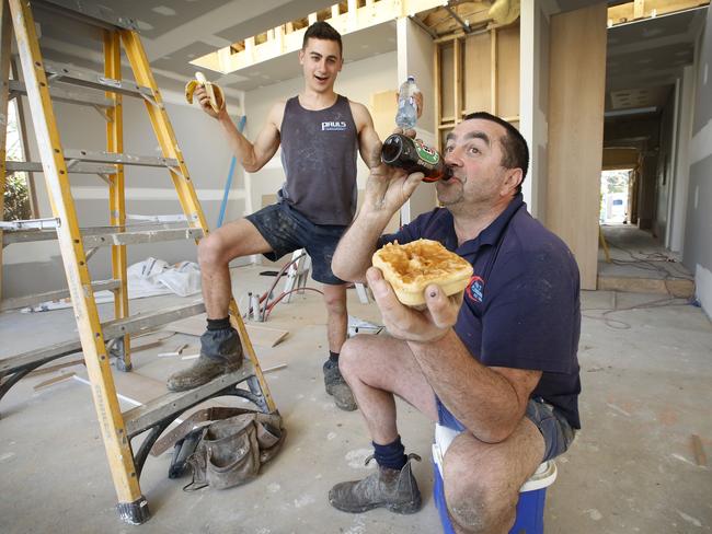 Father and son plumbers Paul and Dylan Di Martino of Paul’s Plumbing Service stop work for very different lunches. Picture: David Caird