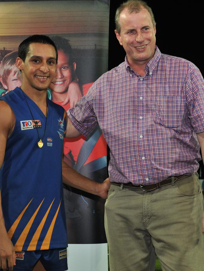 Aaron Motlop after winning the 2011 Chaney Medal, pictured with then-NT Chief Minister Paul Henderson. Picture: Regi Varghese