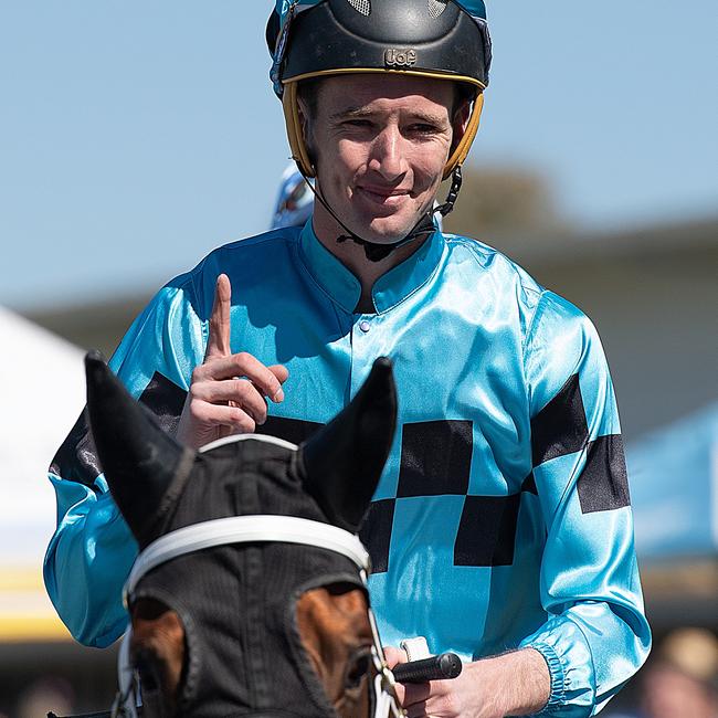 Jockey Ryan Plumb gestures after riding Sugar Sizzle to victory during the Viva Racing Race Day at Gold Coast Turf Club in 2018. Picture: AAP Image/Albert Perez