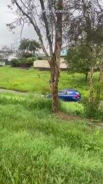 Car stuck in water filled ditch