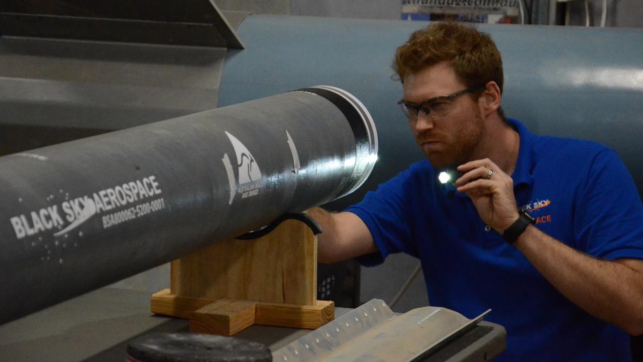 BSA Engineer Bryan Greenham doing a Quality Assurance inspection on the rocket motor