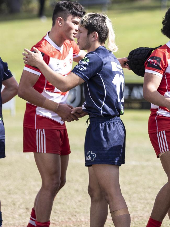 Players from Palm Beach Currumbin SHS’s Keano Kini shakes hands.