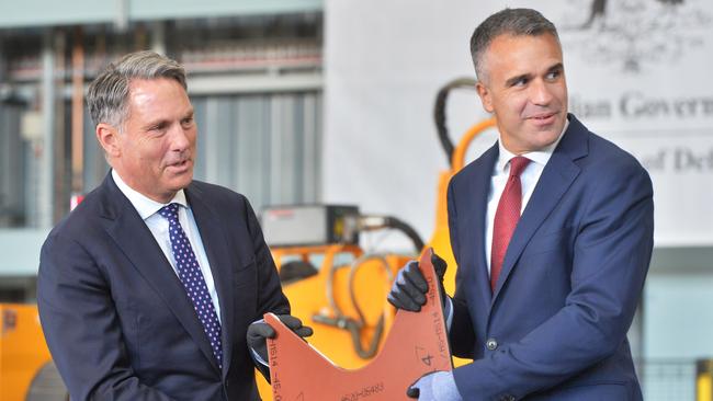 Defence Minister Richard Marles and Premier Peter Malinauskas holding the first cut piece of steel to be used on the first Hunter class frigate to be constructed at the Osborne Naval Shipyard. Picture: NewsWire / Brenton Edwards