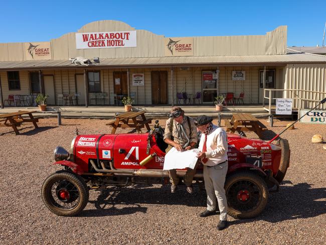 HOTOGRAPHS BY NIGEL WRIGHT., +61 409363339. wrightphoto1@mac.com, 21.01.2095, BIRTLES AND THE BEAN, THIS PHOTOGRAPH SHOWS, IN AUSTRALIA WITH THEIR GLOBE TROTTING, 100 YEAR OLD, CAR, WARREN BROWN AND MATTHEW BENNS ARE RAISING THE RED DUST AND RAISING FUNDS FOR THE ROYAL FLYING DOCTOR SERVICE AS THEY HEAD SOUTH THROUGH OUTBACK QUEENSLAND TOWARDS MELBOURNE., THEY PAUSE, to consider their map IN McKINLAY, a hamlet in outback Queensland at THE ORIGINAL WALKABOUT CREEK HOTELÃ SEEN IN THE CROCODILE DUNDEE FILM., L/r WARREN BROWN & MATTHEW BENNS