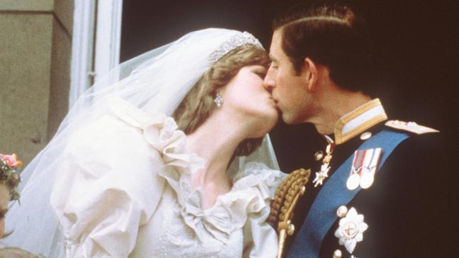 The Prince of Wales kisses his bride, Lady Diana, on the balcony of Buckingham Palace in 1981.