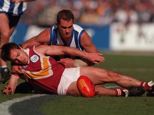 A clash between the Brisbane Bears and North Melbourne, with footballer Shaun Hart (front) and Wayne Schwass.