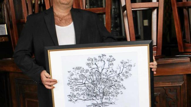 Preferring to work in black and white, Daniel Rofe shows off a charcoal drawing of a tree at Cherrabah Resort. Picture: Sophie Lester