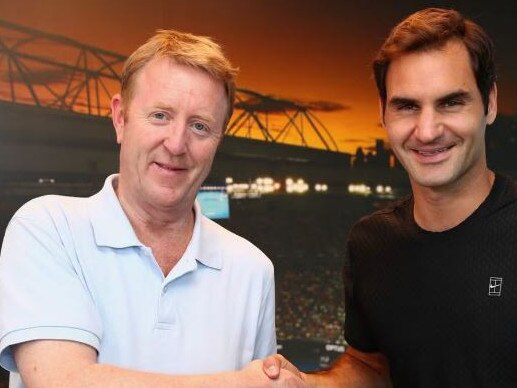 British tennis writer Mike Dickson, with Roger Federer, has died in Melbourne at the age of 59. Picture: Supplied