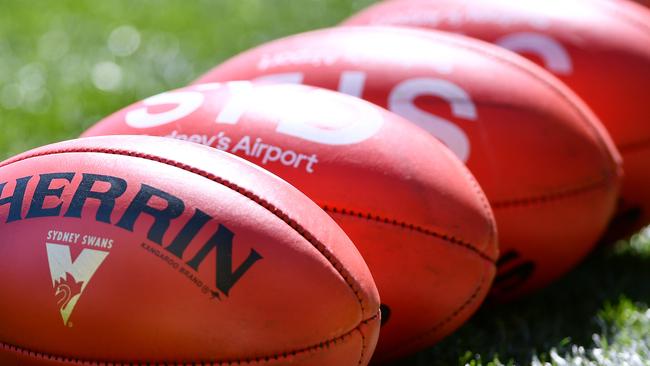 ADELAIDE, AUSTRALIA - AUGUST 29: Sherrin pracitce balls during the round 14 AFL match between the Port Adelaide Power and the Sydney Swans at Adelaide Oval on August 29, 2020 in Adelaide, Australia. (Photo by Mark Brake/Getty Images)