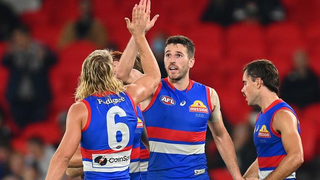 Marcus Bontempelli is congratulated by teammates after kicking a goal. Picture: Quinn Rooney/Getty Images