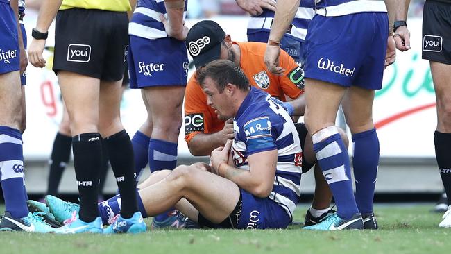 Josh Morris of the Bulldogs receives attention after receiving an elbow to the throat.