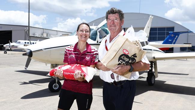 Tanika Parker helps chief pilot of Daintree Air Services Greg Letondeur load supplies onto a light plane to fly essential items to flood victims in Cooktown. Ms Parker helped coordinate the collection of water, food, clothing and sanitary products to be flown north, after record flooding caused by ex Tropical Cyclone Jasper. Picture: Brendan Radke