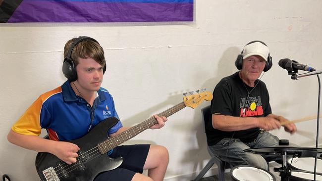 Former AC/DC drummer Ray Arnott (right) mentoring kids aged 12 to 17 in the Social Futures Clubhouse Program. Picture: Supplied