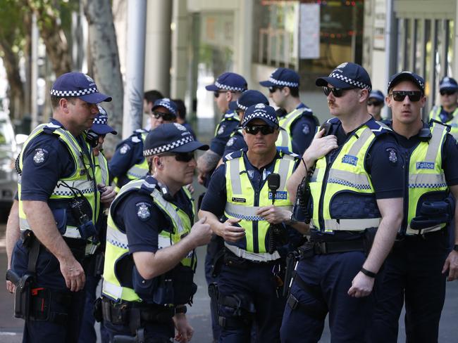 Police wait in numbers before terror suspects face Melbourne Magistrates’ Court. Picture: David Caird