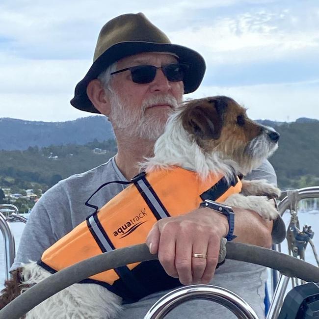 Professor Dennis Pashen with his dog Toby cruises the Channel area in Hobart.
