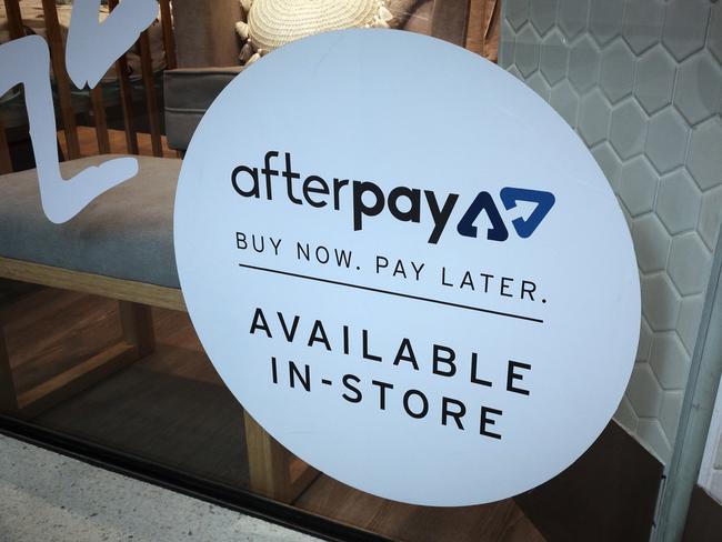 An Afterpay sign is seen in a store window in a shopping centre. Picture: AAP