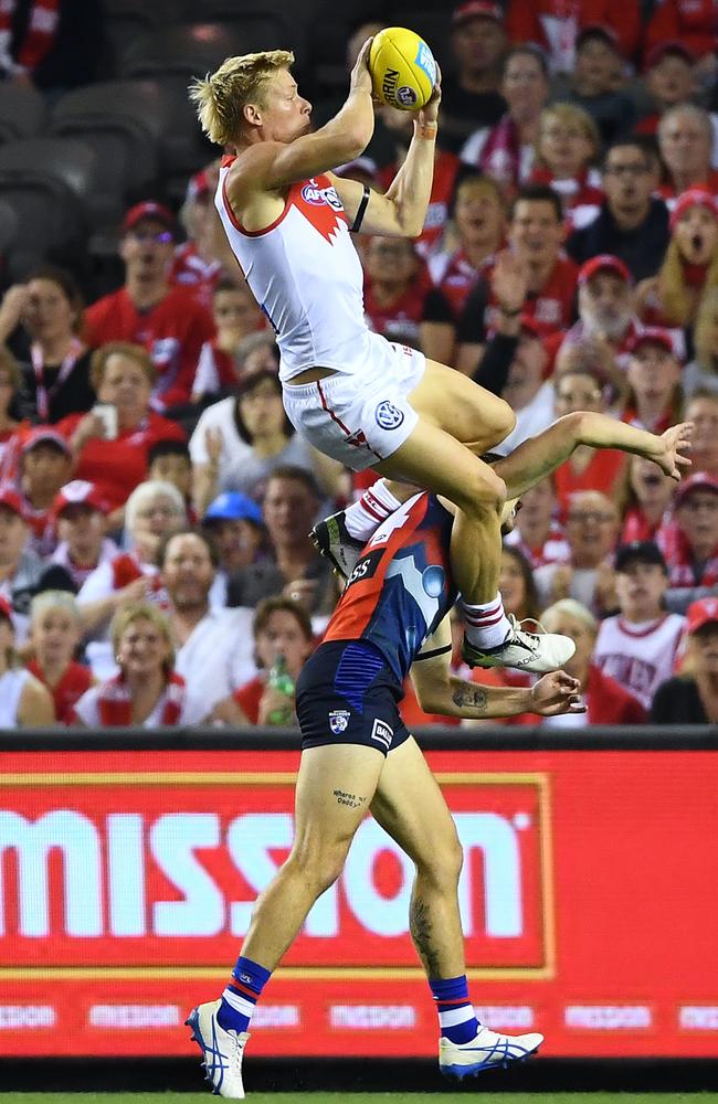 Isaac Heeney flies over Bailey Williams for an early goal of the year contender. Picture: Getty Images