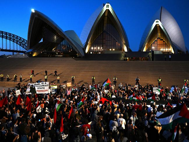 Participants of a Free Palestine rally react outside Sydney Opera House in Sydney, Monday, October 9, 2023. Israel has pounded the Palestinian enclave of Gaza, killing hundreds of people in retaliation for one of the bloodiest attacks in its history when Islamist group Hamas killed 700 Israelis and abducted dozens more. (AAP Image/Dean Lewins) NO ARCHIVING